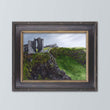 Load image into Gallery viewer, green ireland landscape painting in black frame on light blue background.