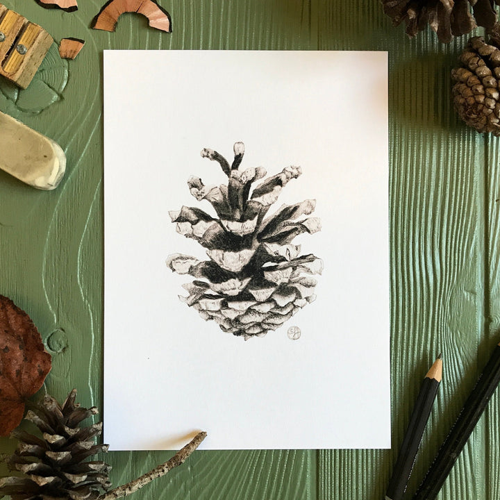 Woodland Pinecone Print on green background with art supplies