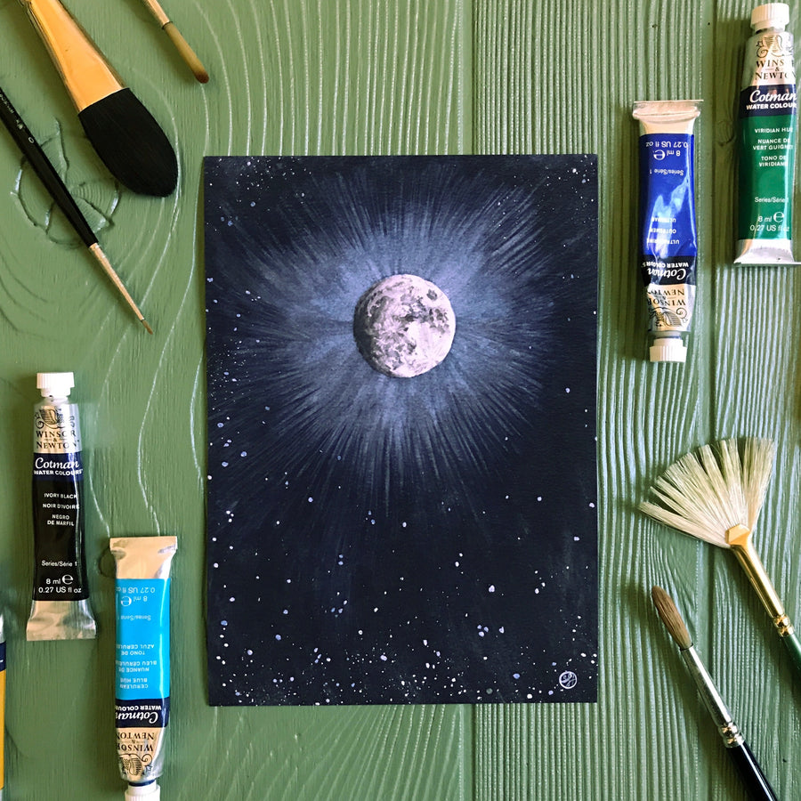 Light Of The Full Moon print on table with art supplies