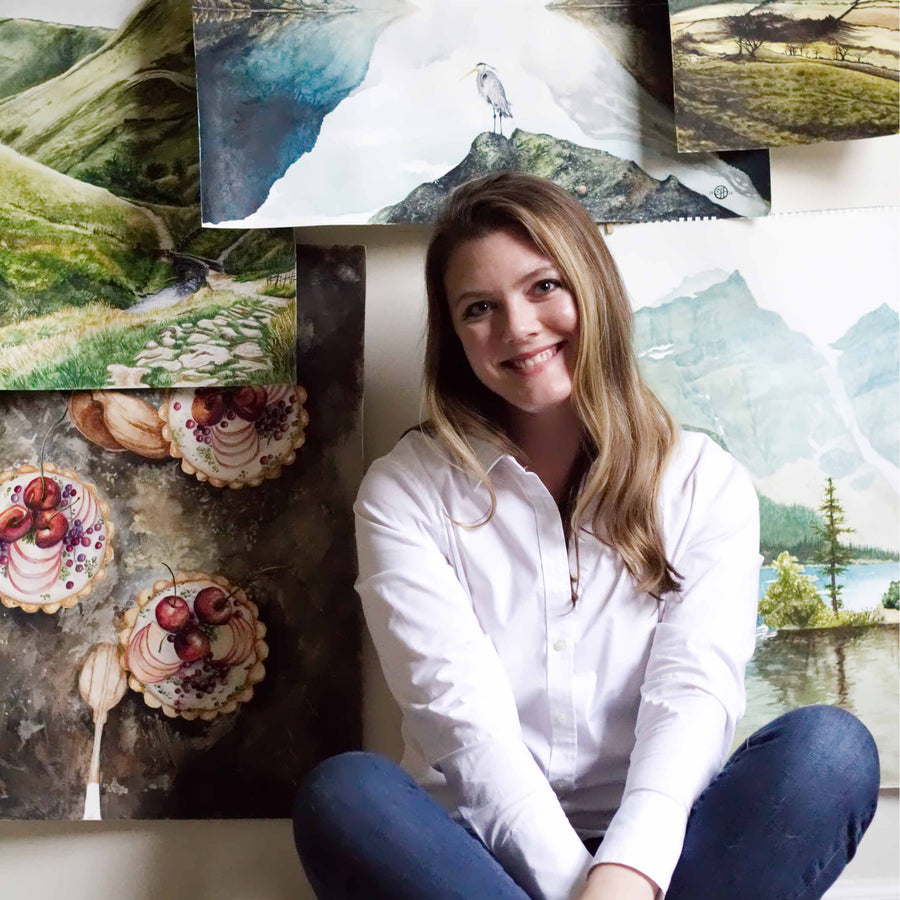 Courtney Hopkins smiling in front of her artwork